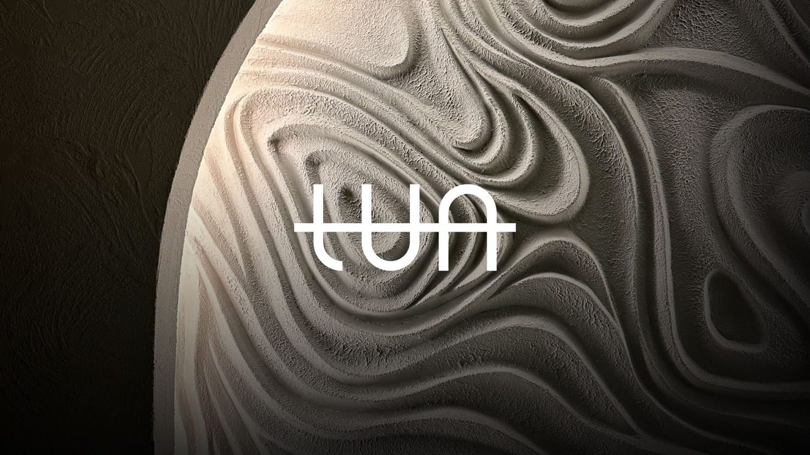 Logo of Tua Interior Design Studio displayed on a textured background with abstract flowing patterns, emphasizing modern and sophisticated design aesthetics.